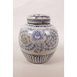 A Chinese blue and white porcelain ginger jar and cover decorated with scrolling floral pattern