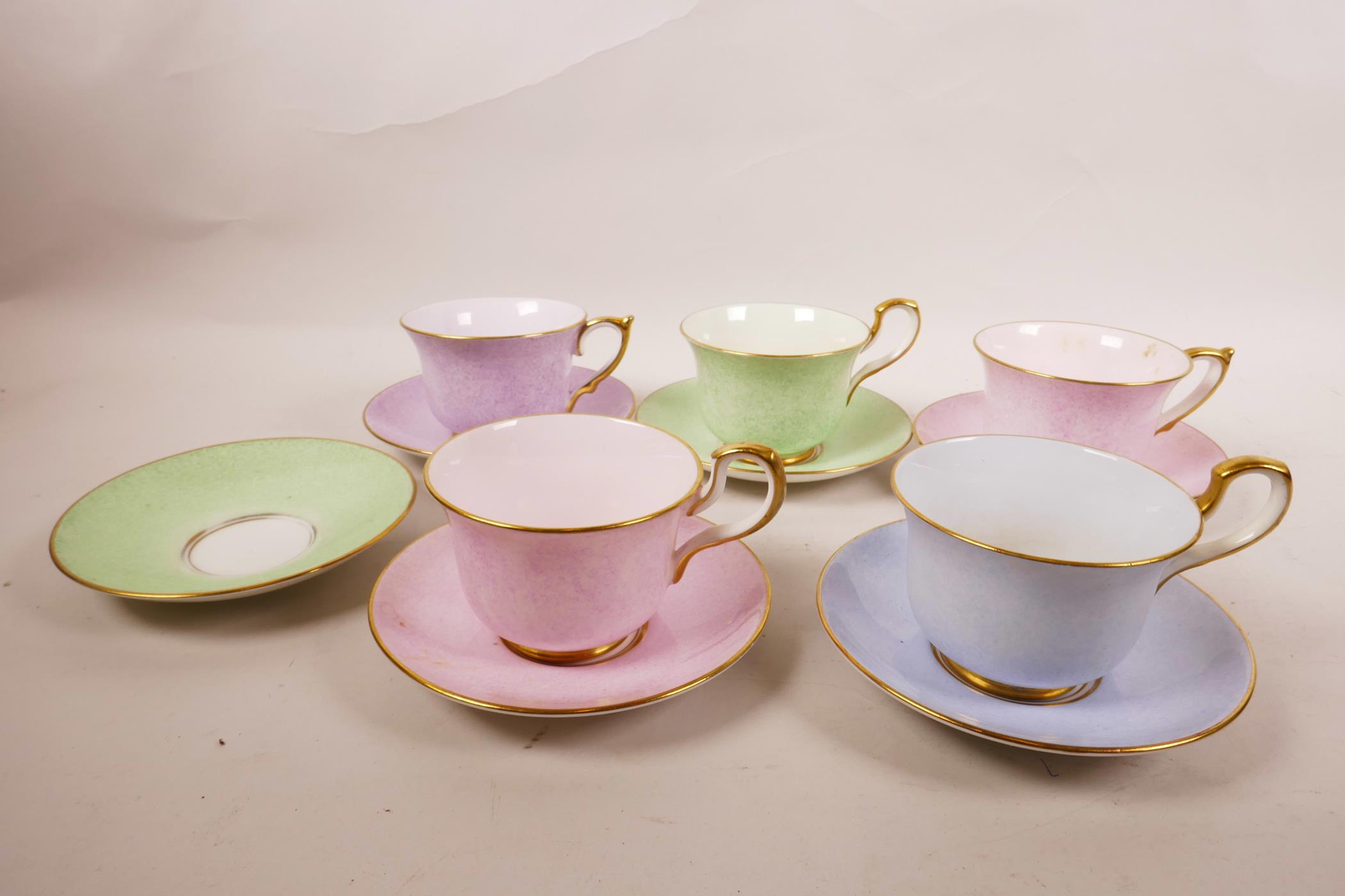 A 1930s Paragon China part tea set, sponged pastel colours of pink, lilac, green and blue, with gilt