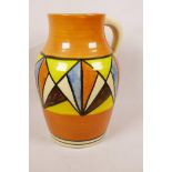 A Clarice Cliff style lotus jug decorated with geometric pattern, 10½" high