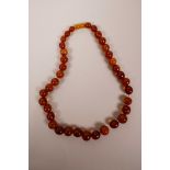 A string of graduated amber beads, 17" long, 33 grams