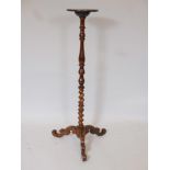 A C19th walnut lamp stand, raised on a turned column and scrolled tripod supports, 39" high