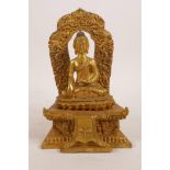 A Sino-Tibetan gilt metal figure of Buddha seated on a throne, impressed mark verso, 7" high