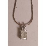An 18ct white gold, emerald cut diamond pendant necklace, approximately half a carat