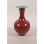 A Chinese flambé glazed pottery vase with a flared edge, 4 character mark to base, 8" high