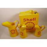 A replica Shell one gallon fuel can, together with three replica oil jugs