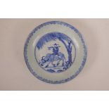 A Chinese blue and white porcelain dish decorated with a figure riding an ox, 8½" diameter