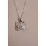 A cubic zirconium and opalite set silver pendant necklace in the form of a cat mask