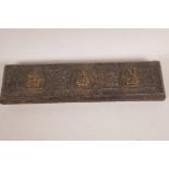 An early Tibetan 'Pecha' loose leaf book, the brass bound wooden covers with applied cast figurines,