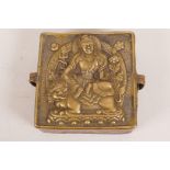 An antique Tibetan bronze box, the cover decorated with Buddha seated on a kylin, 4½" x 4½" x 2"