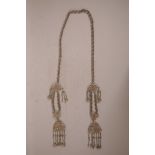 A Chinese white metal twin chatelaine pendant decorated with butterflies, flowers and phoenix, 52"