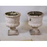 A pair of cast stone garden urns, 25" high