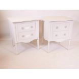 A pair of painted two drawer bedside chests, raised on turned supports, 24" x 20" x 30"