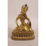 A Sino-Tibetan gilt bronzed metal figure of Buddha seated on a lotus throne, impressed double