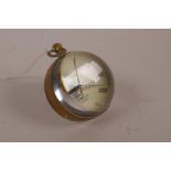 A brass and glass ball desk clock, 2½" diameter