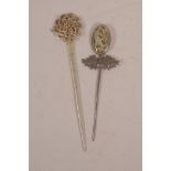 A Chinese white metal hair pin set with a carved jade panel to end, together with a white metal hair