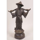 A Chinese bronze figure of a man bearing a yoke, 10" high