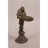 An Indian bronze oil lamp in the form of a goddess, 6½" high