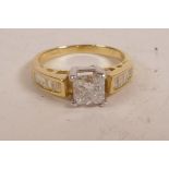 A 14ct yellow gold diamond ring with a central princess cut stone and baguette flanked shoulders,