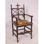 A C19th oak and parcel gilt Gothic style chair with a stretcher carved in the form of a serpent,