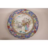 A Chinese Canton enamel decorated porcelain charger depicting figures in a landscape, 13½" diameter