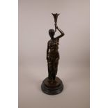 A bronze figure of a classical lady holding a sceptre aloft, on a black marble base, 20" high