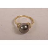 A 14ct gold and Tahitian black pearl dress ring, approximate size 'Q/R'