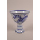 A Chinese blue and white porcelain stem cup decorated with a dragon chasing the flaming pearl, 6