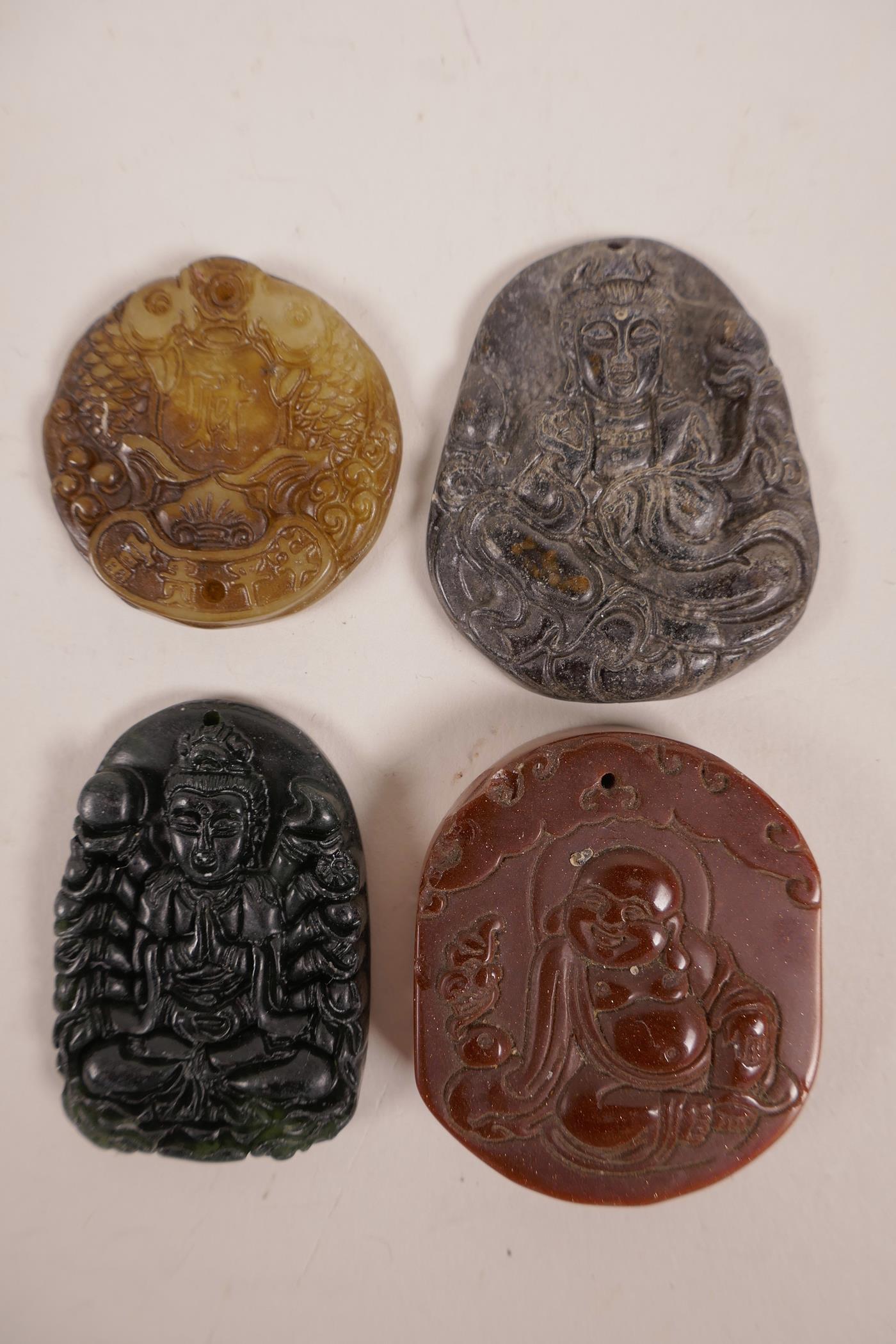 Four Chinese hardstone pendants with carved decoration of carp, Buddha, Quan Yin etc, largest 2"