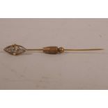 An Edwardian gold stick pin, encrusted with diamonds and seed pearls (one missing), central