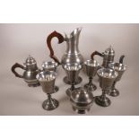 A pewter drinks set comprising jug, 13" high, with six pedestal goblets, tea and coffee pots and