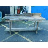 A large wooden work bench with small 'woody' vice, 35" high, 84" long, 29" deep
