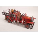 A painted vintage tin plate fire engine, 15½" long