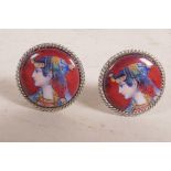 A pair of white metal cufflinks set with cold enamel plaques depicting Eastern women