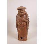A Chinese carved bamboo figure of a fisherman with his catch, 15" high