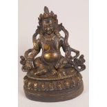 A Tibetan bronze figurine of a seated deity , 7" high