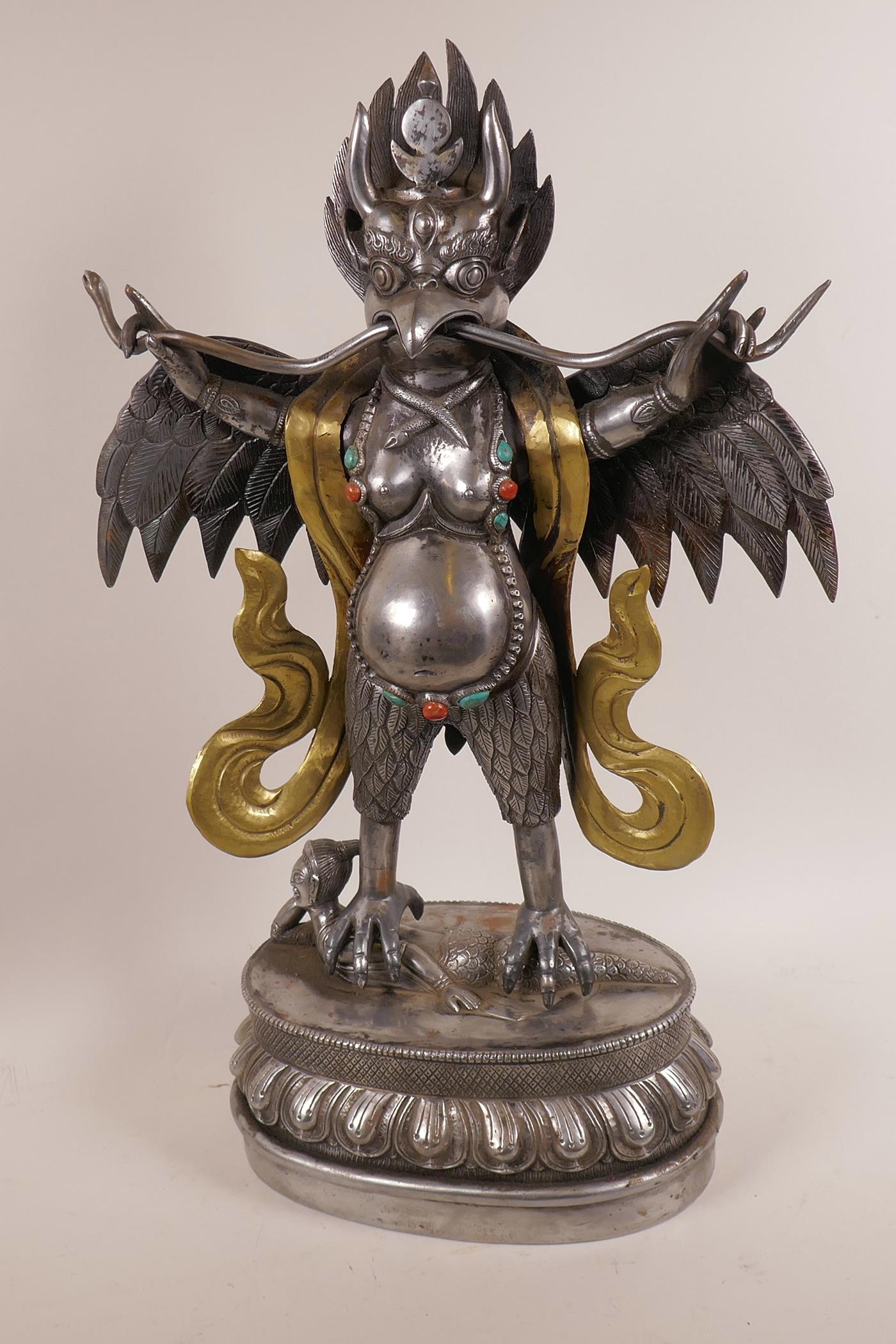 An Asian polished steel and brass figure of the bird deity Garuda, 20" high