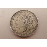 A USA silver Morgan dollar coin minted in Philadelphia and dated 1921; a USA silver Kennedy 1964