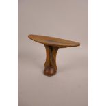 An African carved hardwood head rest, 6½" high x 8" wide