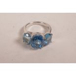 A silver three stone blue topaz dress ring, approximate size 'R'