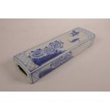 A Chinese blue and white porcelain pillow decorated with waterfowl and flowers, 12" x 3½"