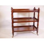 A good early Victorian mahogany three tier buffet, raised on turned supports with spoked brass