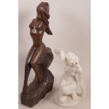 A German Bisque figurine of a nude female, together with another carved hardwood figurine of a