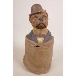 A German tobacco jar of a dog, signed to base, overpainted red clay, 9½" x 4½"