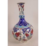 An Iznik pottery lotus pattern vase, decorated in bright enamels, 11½" high