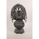 A Sino-Tibetan bronze of a deity with many arms and multiple heads seated on a lotus flower, mark to