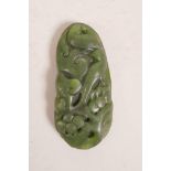 A Chinese spinach jade pendant decorated with birds amongst flowers, 3" long