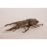 A Japanese Jizai style bronzed copper stag beetle, impressed stamp to base, 5½" long