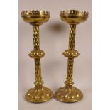 A pair of ecclesiastical brass candlesticks with cushion design column, 18" high