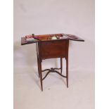 An Edwardian mahogany workbox, the top opening to reveal a fitted interior, raised on sabre legs and