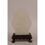 A Chinese white agate carving of Buddha, on a carved hardwood stand, 6½" high